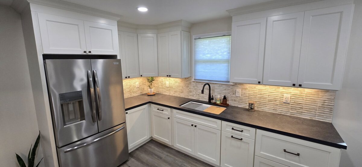 Kitchen-Remodel-–-White-Cabinets-and-Dark-Countertops-1200x554.jpg