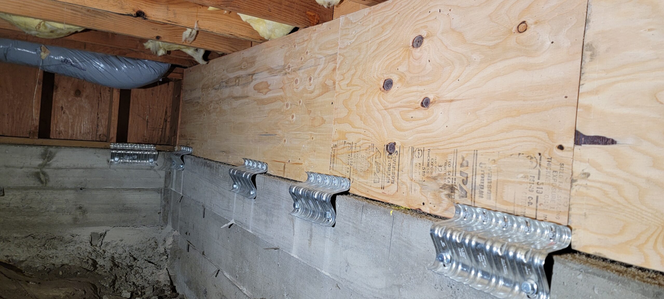 Crawl-space framing with plywood shear panels and metal foundation connectors